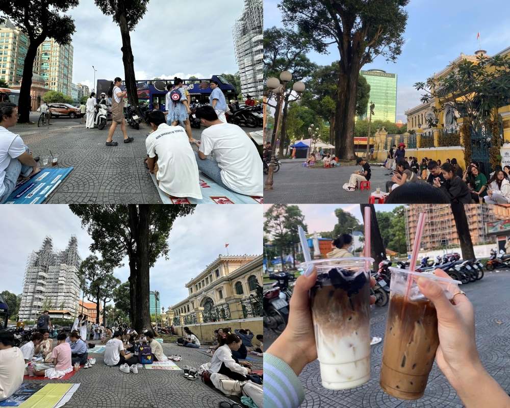 Nhóm bạn trẻ tụ tập uống cà phê ngoài trời ở công viên, khung cảnh bình yên với cây xanh và tòa nhà.