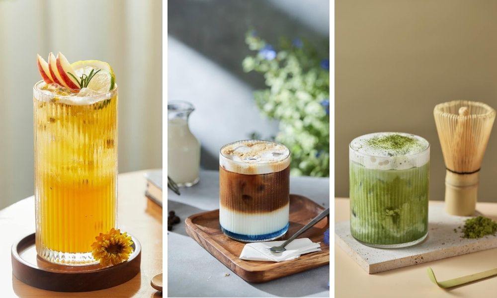Khám Phá Top Quán Cafe Hấp Dẫn Trên Đường Nguyễn Chí Thanh - Điểm Đến Thú Vị 4 Ba ly đồ uống khác nhau được trang trí đẹp mắt, đặt trên bàn với các phụ kiện trang trí.