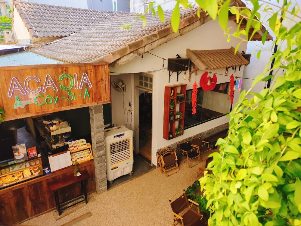 Top 11+ Quán Cafe Đẹp Tại Đà Nẵng Không Thể Bỏ Qua Năm 2025 20 Quán cà phê với bảng hiệu "ACACIA", không gian mở, trang trí cây xanh và ghế ngồi ngoài trời.