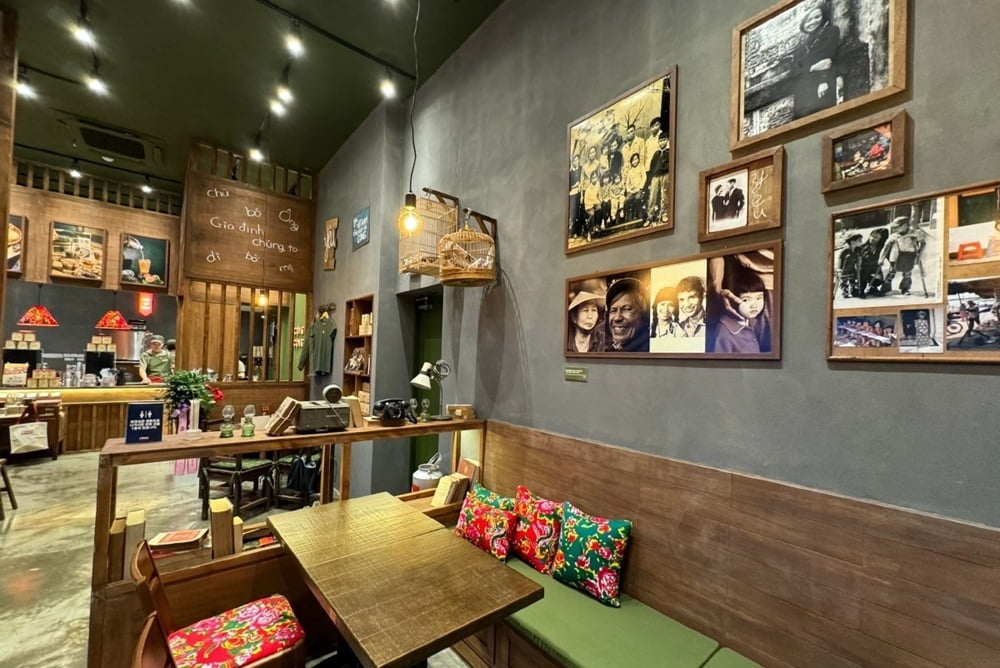 Khám Phá 15+ Quán Cafe View Đẹp, Đồ Uống Ngon Tại Hoàng Cầu 7 Quán cà phê với nội thất gỗ, bàn ghế và những bức ảnh trang trí trên tường tạo cảm giác ấm cúng và hoài cổ.