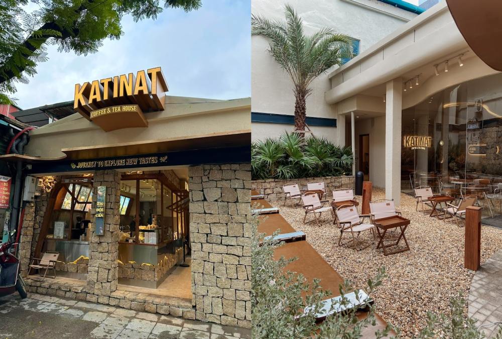 Khám Phá 11 Quán Cafe Đội Cấn Tuyệt Vời Cho Thư Giãn Và Làm Việc 21 Hình ảnh một quán cà phê với bảng hiệu lớn, bên ngoài có khu vực ngồi ngoài trời với ghế và bàn nhỏ.