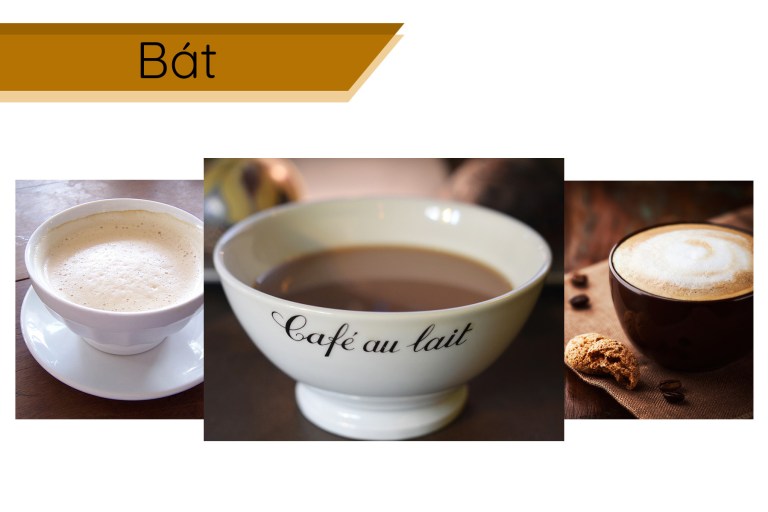 Ba bát cà phê với bọt sữa, chữ "Café au lait" trên bát giữa, đặt trên nền gỗ và khăn vải nâu.
