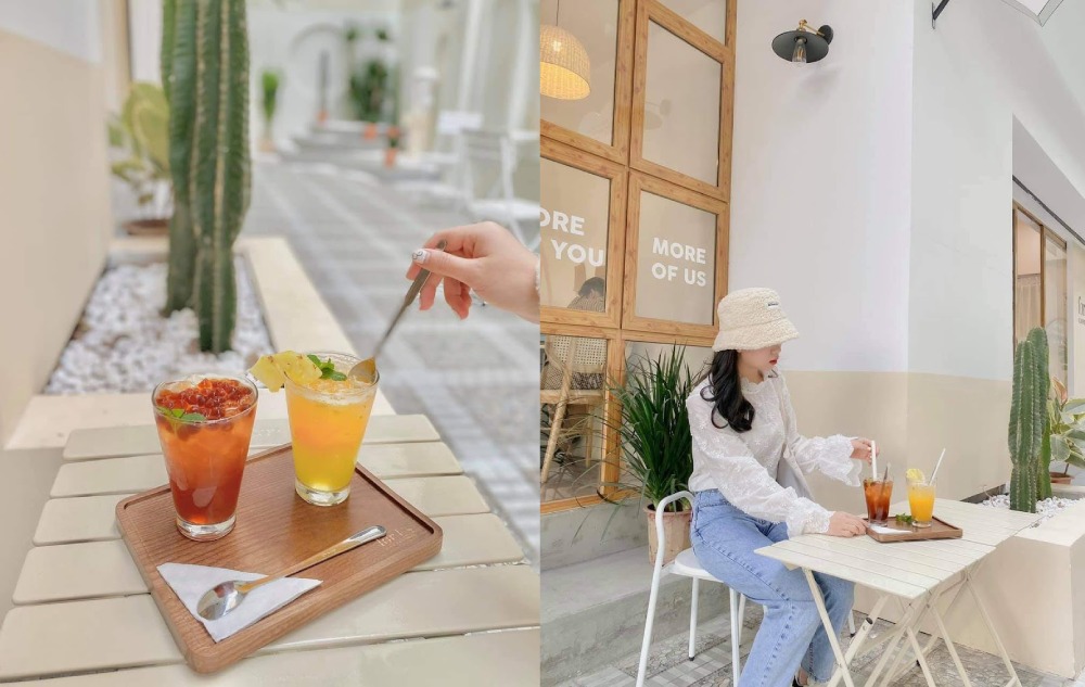 Khám Phá 7 Quán Cafe Tuyệt Đẹp Ở Ngã Tư Sở: View Đẹp, Đồ Uống Ngon, Giá Phải Chăng 4 Người ngồi ngoài quán cà phê, thưởng thức đồ uống trên bàn, xung quanh có cây xanh và trang trí hiện đại.