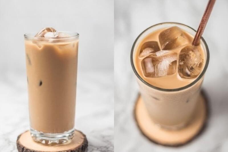 Hai ly cà phê sữa đá trên đế gỗ, một ly nhìn từ trên xuống, ly còn lại nhìn từ bên cạnh.