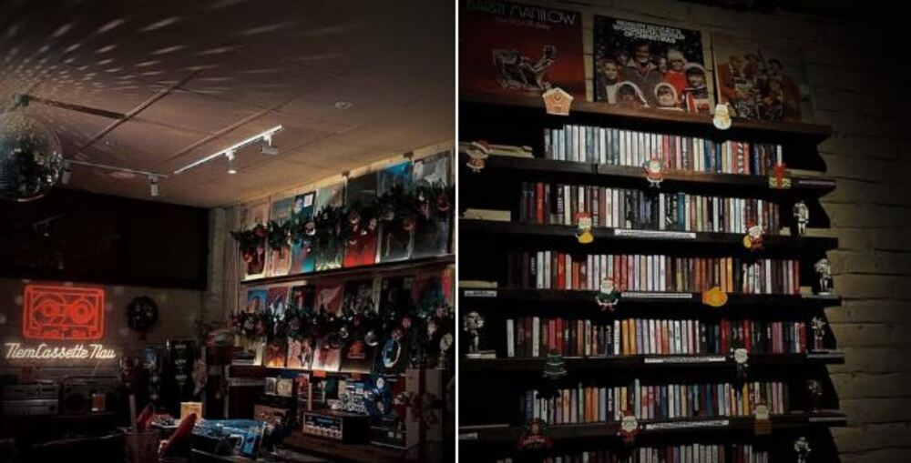 Khám Phá 9 Quán Cafe Độc Đáo Trên Đường Hoàng Hoa Thám 16 Cửa hàng băng cassette với ánh sáng ấm áp, băng đĩa và đồ trang trí trên kệ gỗ.