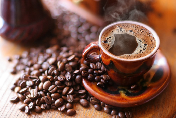 Khám Phá Bí Thuật Cảm Nhận Hương Vị Chân Thực Từ Tách Cà Phê Nguyên Bản và Cổ Điển 3 Tách cà phê nóng bốc khói trên đĩa, xung quanh là hạt cà phê trên bề mặt gỗ.