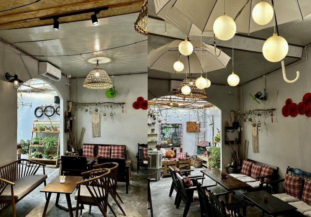 0fa35c60-cafe-da-nang-19 Quán cà phê với nội thất gỗ, đèn treo và cây xanh trang trí, tạo không gian ấm cúng và thư giãn.
