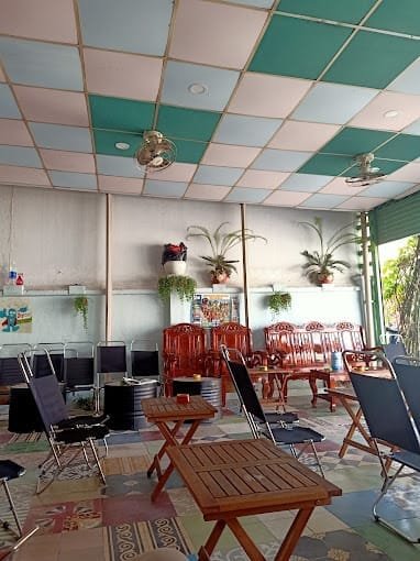 Gợi ý 14 quán cà phê chòi mát mẻ, thư giãn tại TPHCM 14 Quán cà phê với bàn ghế gỗ và kim loại, trần nhà màu sắc. Cây xanh trang trí trên tường, ánh sáng tự nhiên từ cửa sổ.