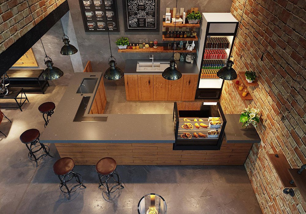 Qu&aacute;n c&agrave; ph&ecirc; nh&igrave;n từ tr&ecirc;n cao với quầy phục vụ, ghế đẩu, tủ trưng b&agrave;y b&aacute;nh ngọt, v&agrave; tường gạch trang tr&iacute;.