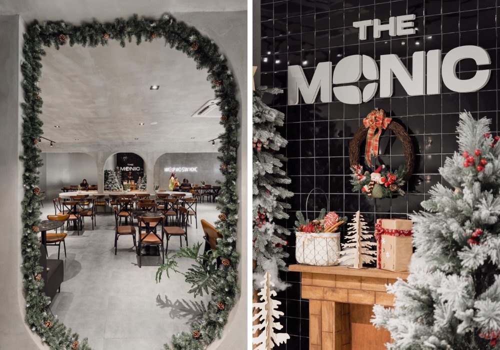 Không gian quán cafe trang trí Giáng sinh với vòng hoa, cây thông và quà trên nền gạch đen.