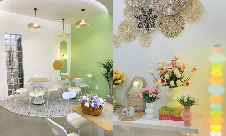 Kh&ocirc;ng gian qu&aacute;n c&agrave; ph&ecirc; trang tr&iacute; hiện đại với b&agrave;n ghế trắng, c&acirc;y xanh v&agrave; hoa tươi tr&ecirc;n b&agrave;n v&agrave; kệ.