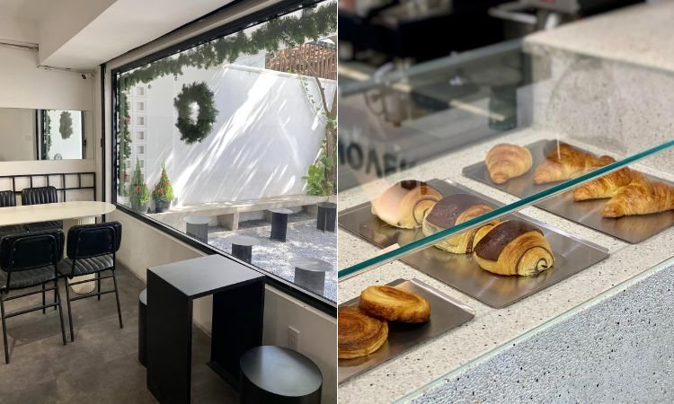 Qu&aacute;n c&agrave; ph&ecirc; với cửa sổ lớn, nội thất tối giản v&agrave; tủ k&iacute;nh trưng b&agrave;y nhiều loại b&aacute;nh ngọt.